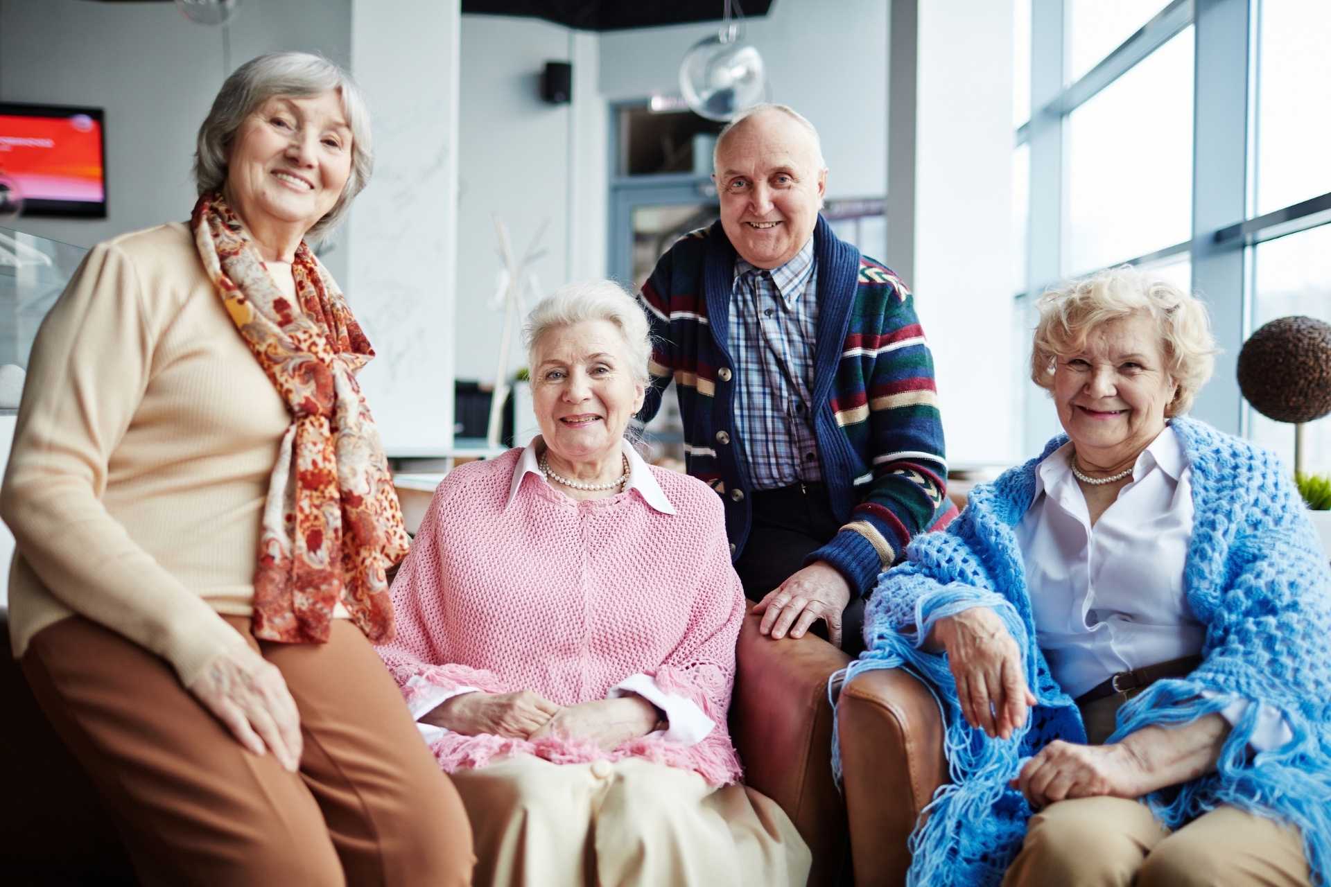 A group of happy seniors posing together and smiling.